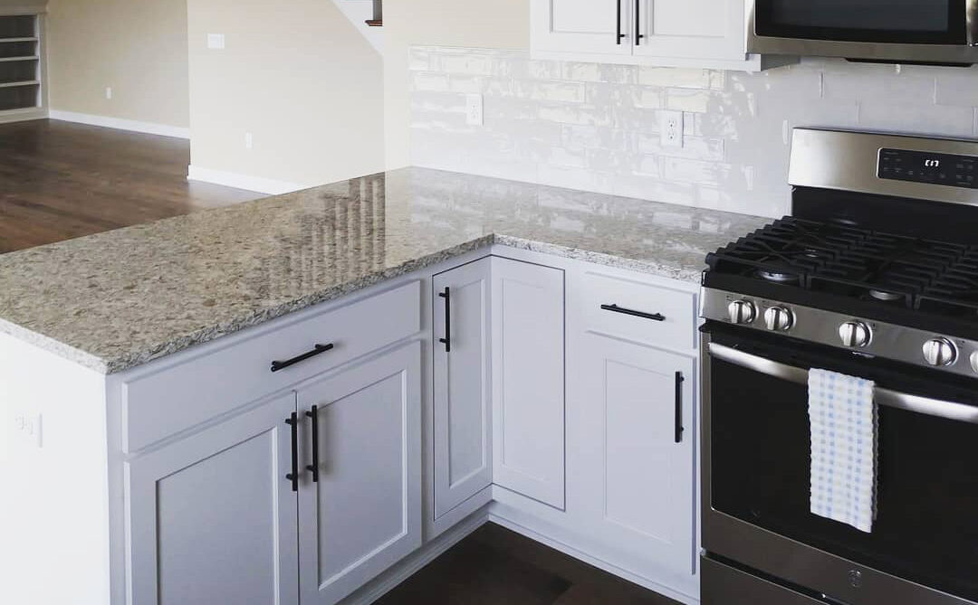 Small kitchen remodel with vertical cabinets and pull-out drawers for optimized space and functionality.